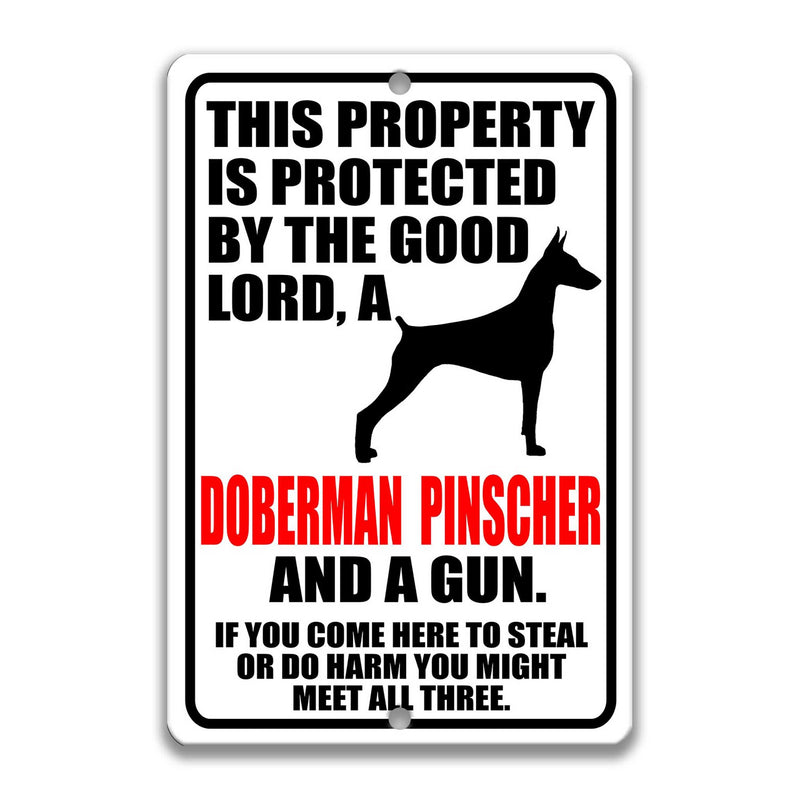 Lord, Doberman Pinscher and a Gun Sign